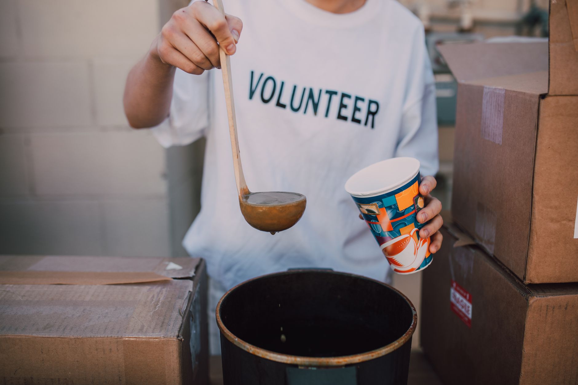 A volunteer serving food at a community event