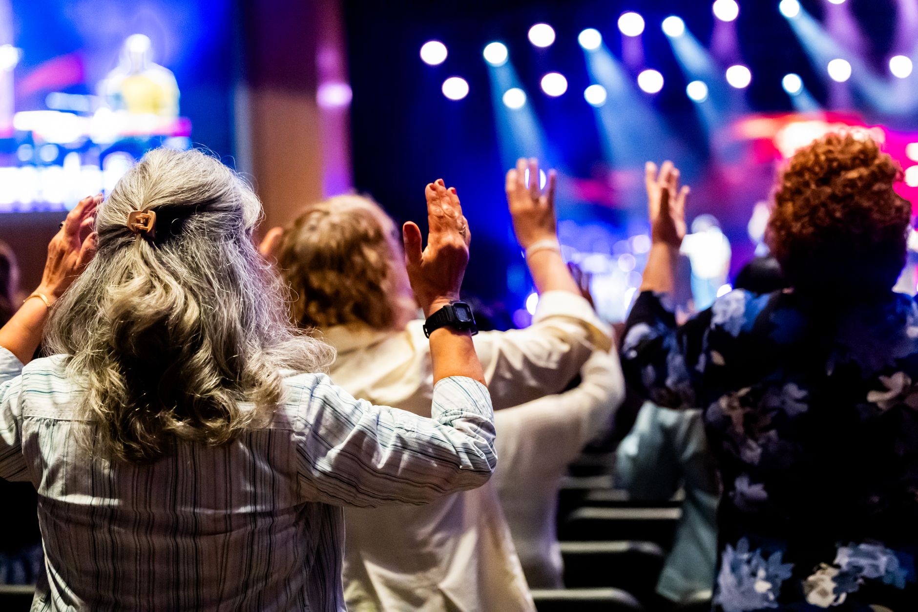 Congregation with raised hands during a worship service